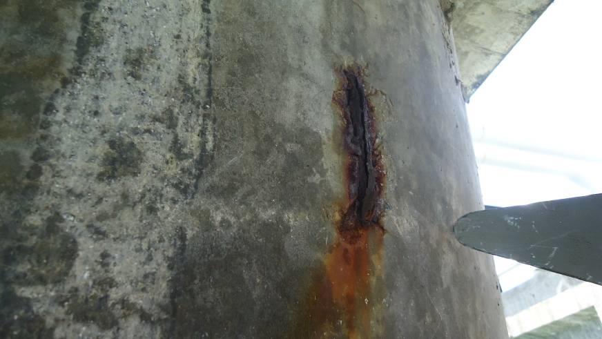 Pile surface showing insufficient concrete cover and reinforcement corrosion, documented in the 2014 source report.