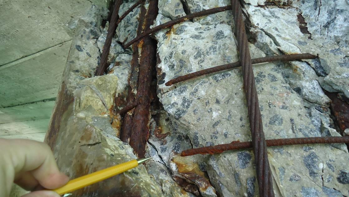 Close-up of reinforcement with section loss and spalled concrete, documented in the 2014 source report.