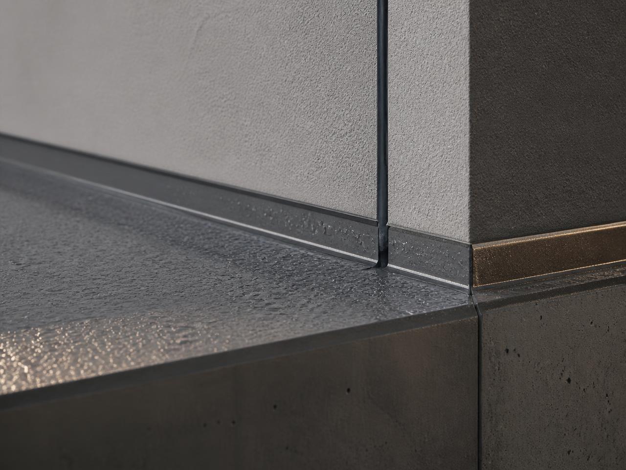 Close-up of a sealed expansion joint, stucco plane and waterproofed deck edge